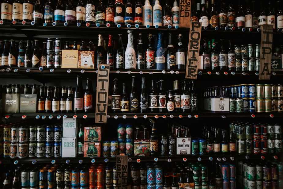 5 shelves of different types of beer and different brands