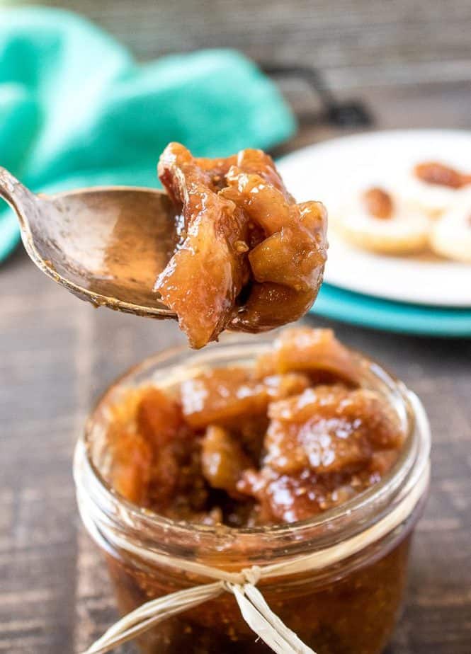 A small mason jar with a piece of raffia tied around the mouth, holds vanilla fig jam