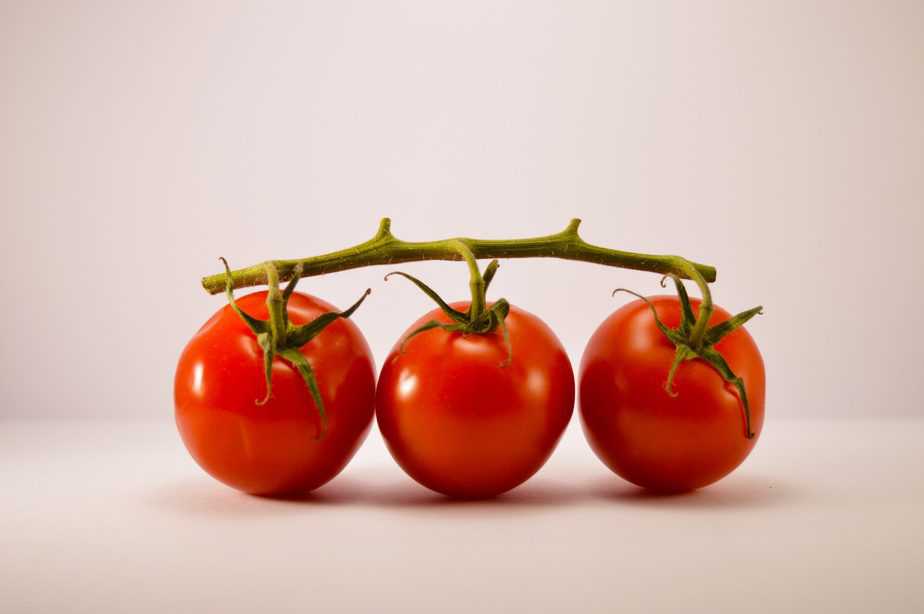 3 red cherry tomatoes on a vine