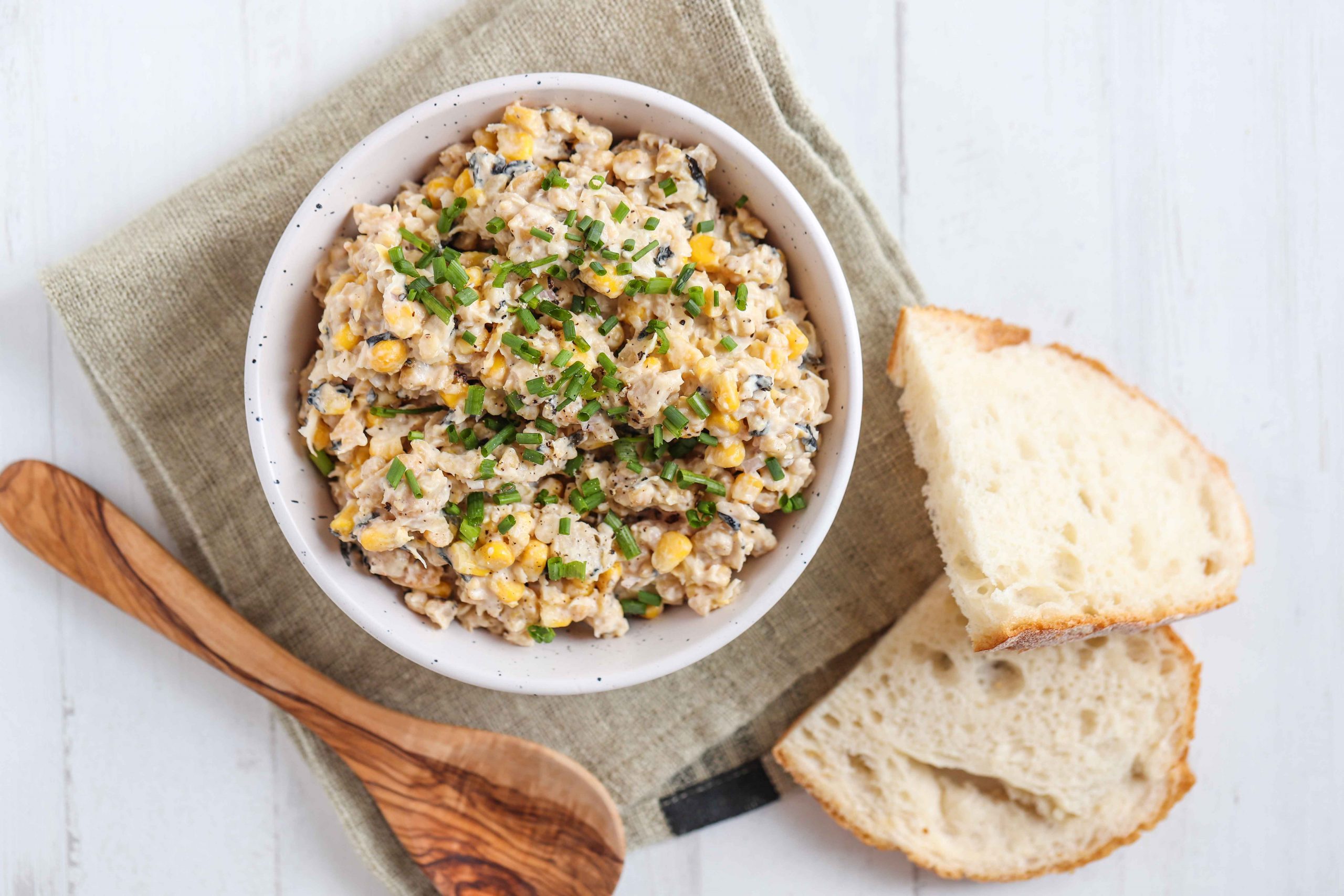 Chickpea tuna salad in bowl with slices of bread