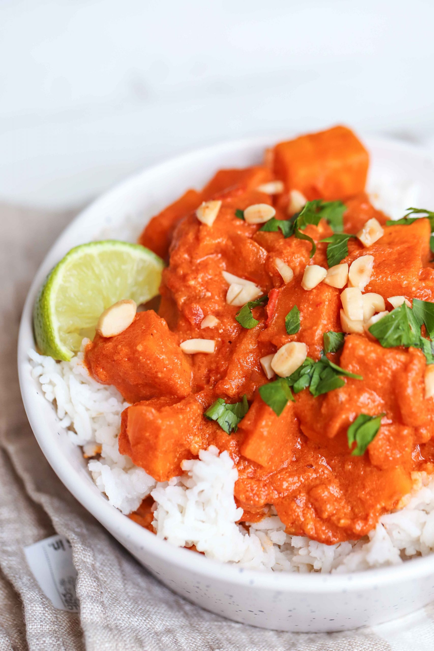 red sweet potato curry over white rice in a white bowl