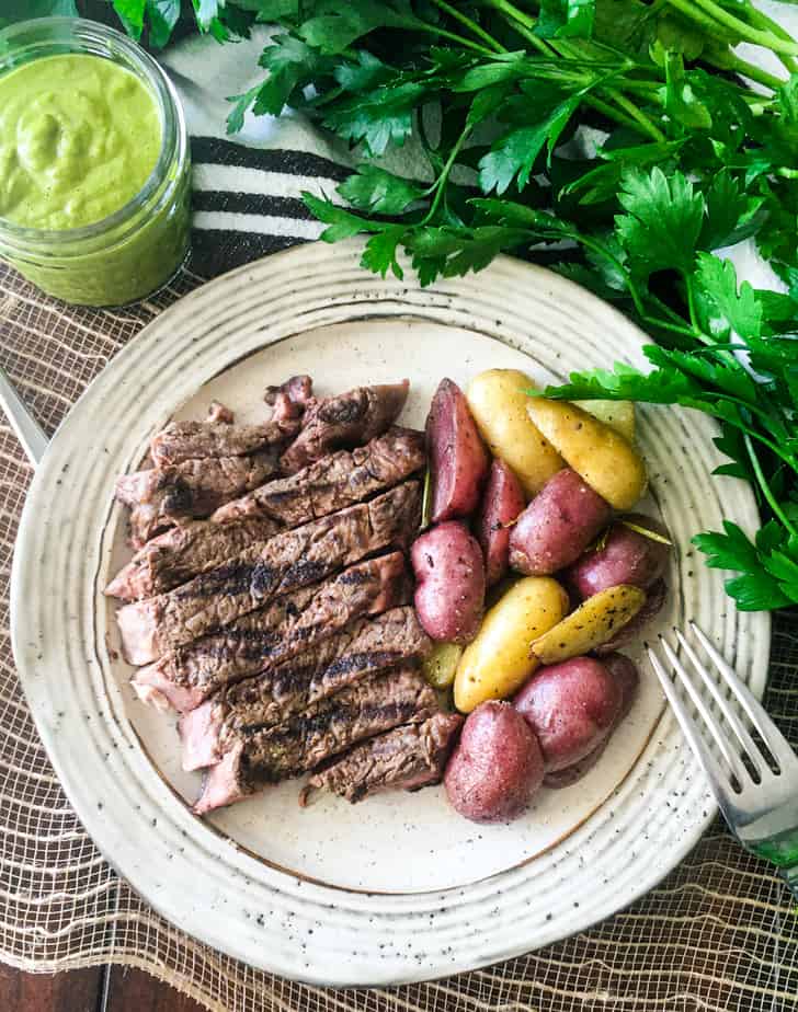 how do you cook a ribeye - ribeye on a plate with potatoes