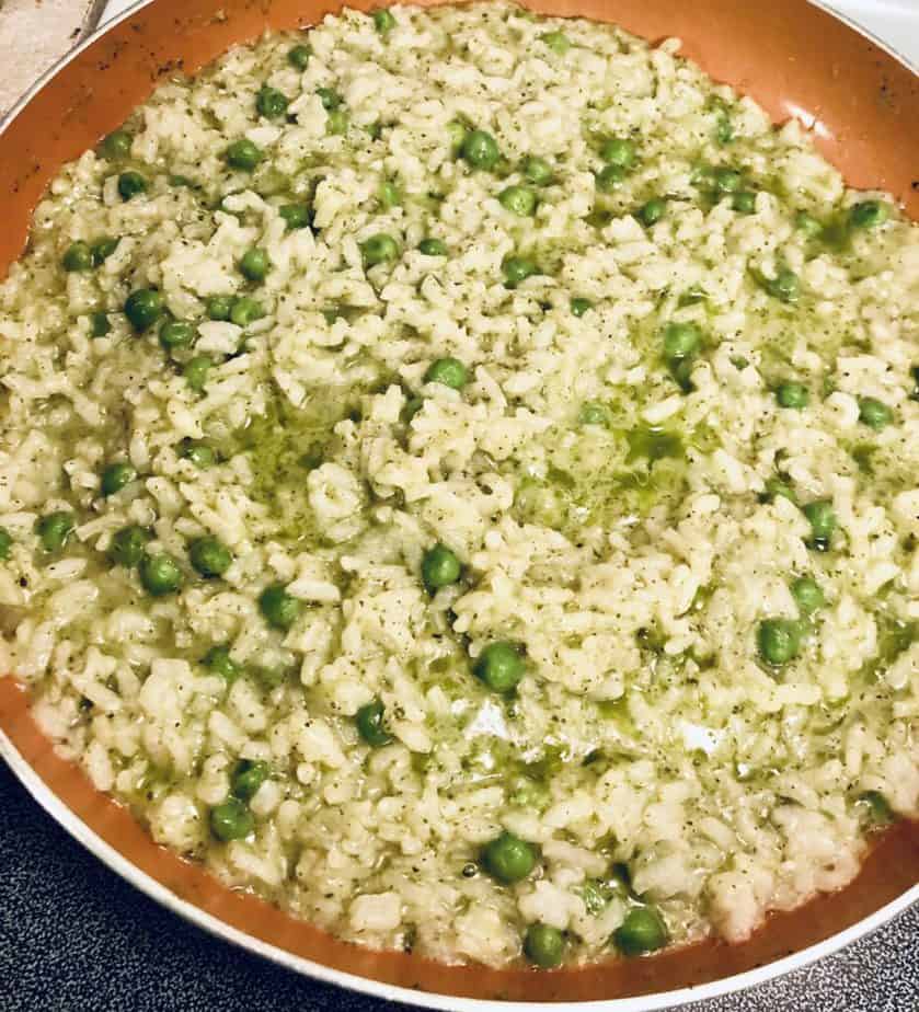 Copper pan with risotto, peas and a pesto sauce