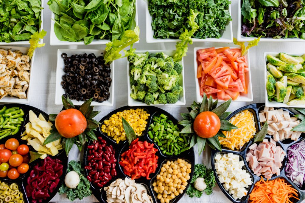 good nutrition a white table full of white and black dishes filled with vegetables and fruits