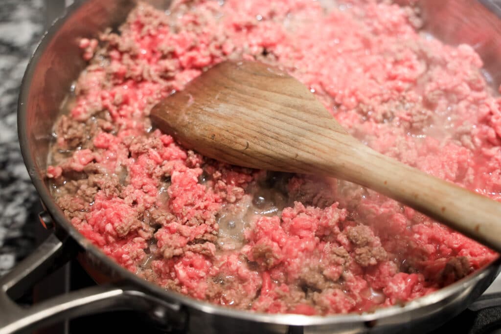 Ground beef in a skillet frying