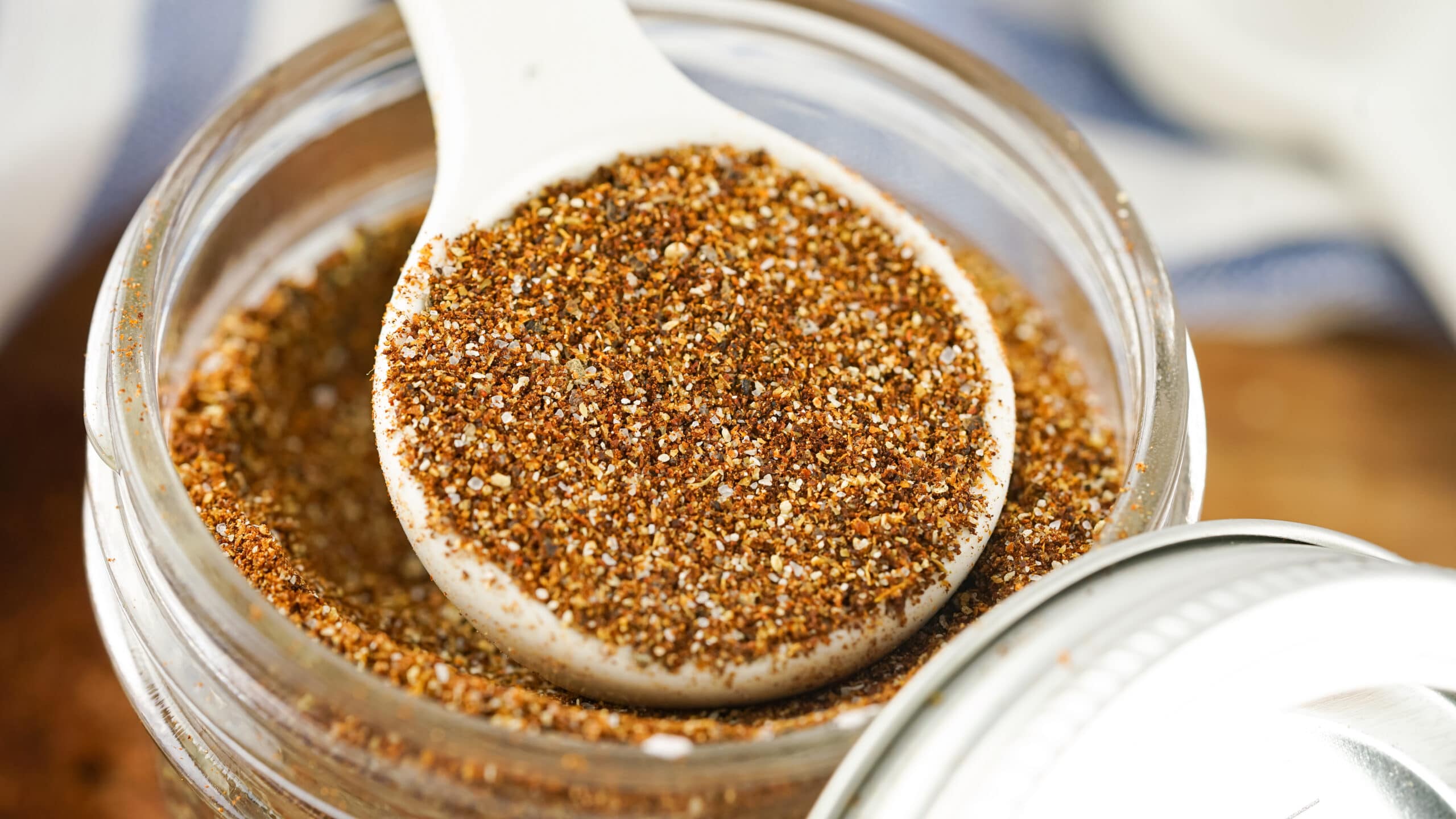 chili seasonings in a jar with a spoonful of the spices