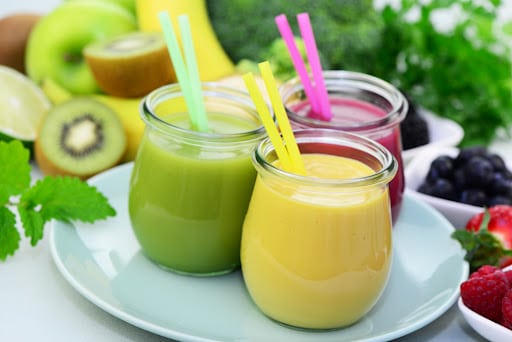 Different types of fruit smoothie with fresh fruit