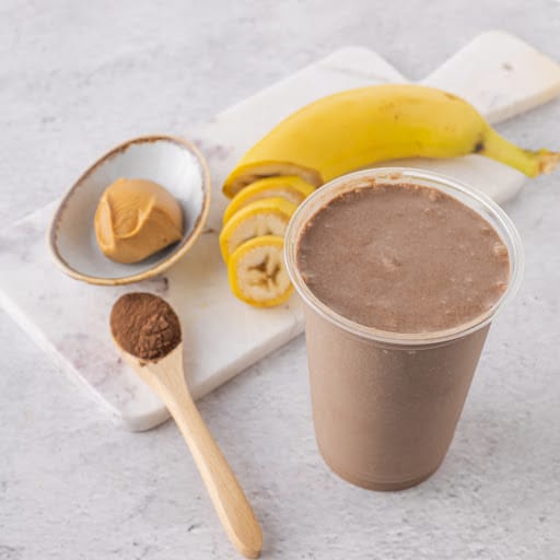 Healthy smoothie with peanut butter, almond milk, banana and cocoa.