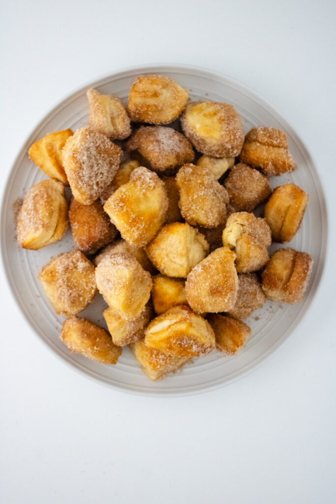 cinnamon sugar coated biscuit bites placed on a glass plate