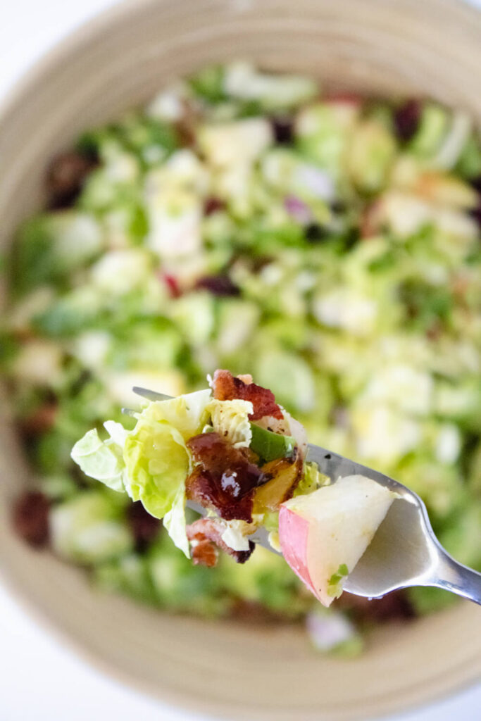 brussels sprout salad with maple dressing with a fork
