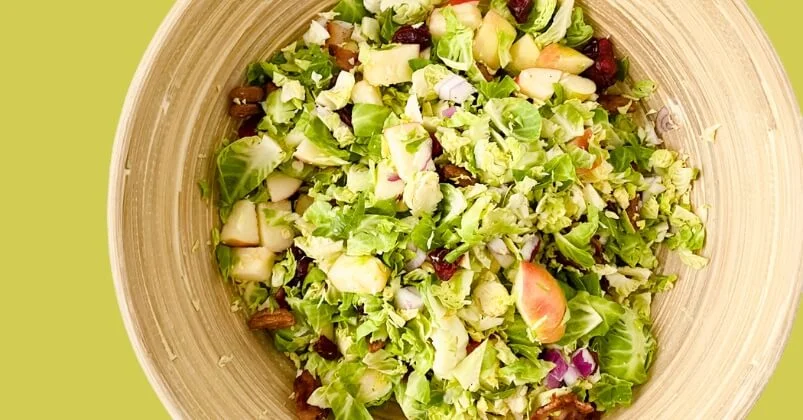 brussels sprout salad with maple dressing in bowl