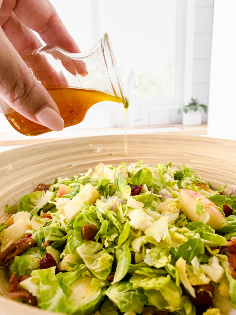 maple vinaigrette poured on the brussels sprout salad