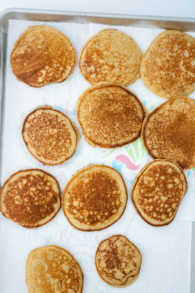multiple pieces of cooked banana oat pancakes placed on a tray