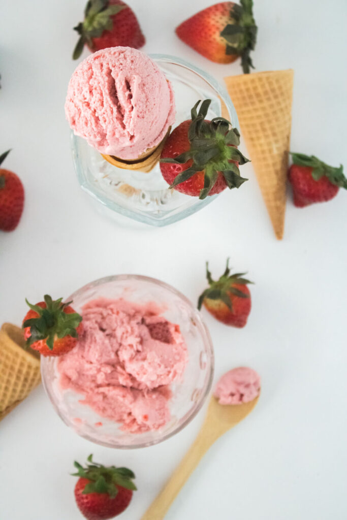 stawberry ice-cream cone and a small bowl of ice-cream along with fresh strawberries