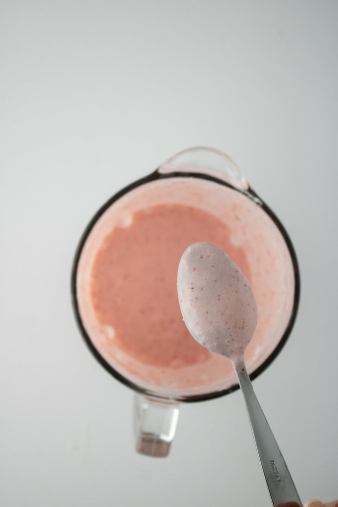 strawberry puree in the blender with a spoon