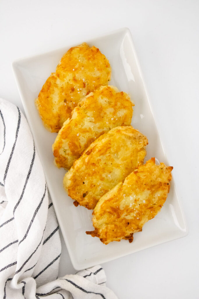 fried homemade hashbrowns arranged on white plate