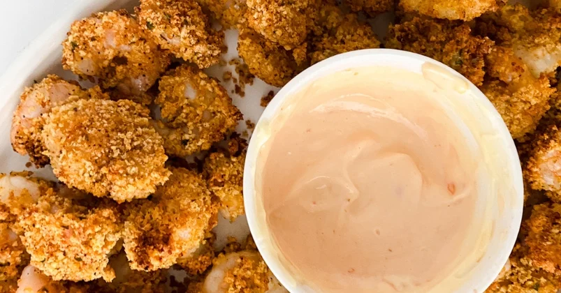 Air Fryer Popcorn Shrimp in white plate with dipping sauce