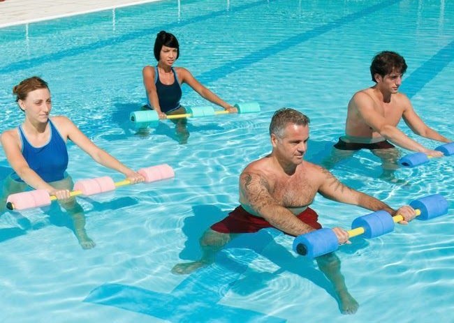 group of people engaged in a water-based exercise class focusing on arthritis management